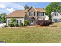 Charming home featuring a well-manicured lawn and a mix of brick and vinyl siding at 3941 Kings Pl, Ellenwood, GA 30294