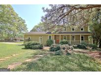 Charming two-story home with a welcoming front porch and beautifully landscaped front yard at 401 Waterwood Bnd, Peachtree City, GA 30269