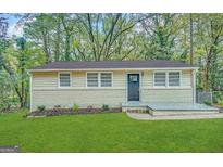 Charming single-story home with a brick foundation and a well-manicured lawn at 3332 Ruby H Harper Se Blvd, Atlanta, GA 30354