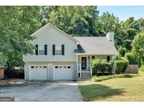 Charming two-story home with a two-car garage and a well-manicured lawn at 127 Muirwood Dr, Temple, GA 30179