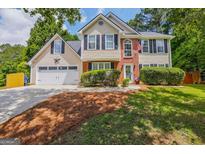 Charming two-story home with a well-maintained lawn and American flag displayed at 2060 Lake St, Loganville, GA 30052