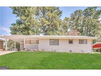 Charming single-story home with a well-manicured lawn and covered entry at 2610 Preston Dr, Decatur, GA 30034
