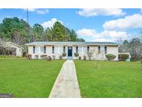 Charming single-story home featuring a well-manicured lawn and inviting walkway at 660 Thomasville Se Blvd, Atlanta, GA 30315