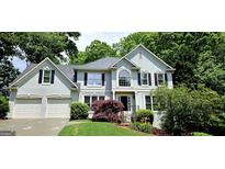 Charming two-story home with manicured lawn, a two-car garage and inviting front entrance at 1008 Stonekirk Trce, Lawrenceville, GA 30043