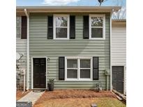 Charming two-story home with black shutters, a black front door, and a manicured lawn at 4282 Worth Nw St, Acworth, GA 30101