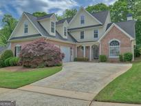 Beautiful two story home with manicured lawn, brick accents, and a two car garage at 187 Eagles Club Dr, Stockbridge, GA 30281