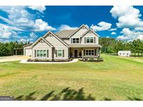 Charming two-story home with manicured front yard and lush green lawn at 107 Corinth Reserve Pl, Grantville, GA 30220