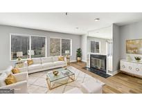Bright living room boasts hardwood floors, fireplace, and large windows at 27 Lakes Edge Se Dr, Smyrna, GA 30080