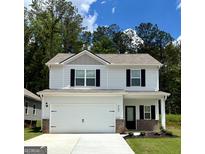Charming two-story home featuring a spacious garage, black accents, and a well-manicured lawn at 449 Prescott Way, Villa Rica, GA 30180