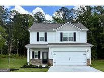 Charming two-story home features a two-car garage, black shutters, and a well-manicured lawn at 467 Prescott Way, Villa Rica, GA 30180