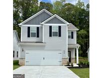 Charming two-story home boasts a modern facade, a spacious garage, and manicured landscaping at 439 Prescott Way, Villa Rica, GA 30180