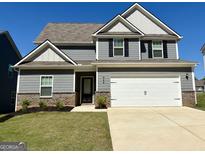Charming two-story home with gray siding, brick accents, and a well-manicured lawn at 448 Prescott Way, Villa Rica, GA 30180
