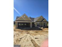 Under construction, this new home features a two-car garage, black shingle roof and is nestled on a spacious lot at 3269 Broadnax Mill Rd # 1, Loganville, GA 30052