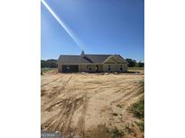 New construction home featuring a side entry garage, chimney, and a classic gable roof design at 3261 Broadnax Mill Rd # 2, Loganville, GA 30052