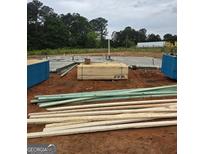 A construction site shows the foundation and framing materials for a new home build at 3245 Broadnax Mill Rd # 7, Loganville, GA 30052