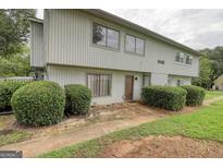 Two-story home featuring light siding, well-maintained landscaping, and a welcoming front entrance at 1448 Pine Log Ne Rd # C, Conyers, GA 30012