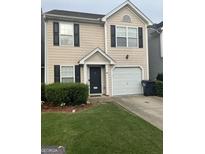 Charming two-story home with attached garage and well-maintained lawn at 45 Fieldview Ln, Covington, GA 30016
