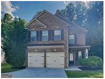 Charming two-story brick home with a two-car garage and a well-manicured lawn at 749 Rolling Downs Dr, Loganville, GA 30052