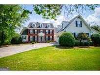 Charming two-story brick home featuring a well-manicured lawn and a circular driveway, enhancing its curb appeal at 1745 Stripling Chapel Rd, Carrollton, GA 30116