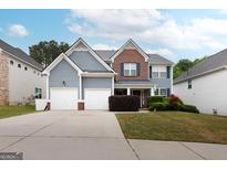 Charming two-story home with a well-maintained lawn and attached two-car garage at 1144 Simonton Hill Ct, Lawrenceville, GA 30045
