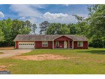 Charming single-Gathering home with a well-maintained lawn and attached garage at 1170 Peeksville Rd, Locust Grove, GA 30248