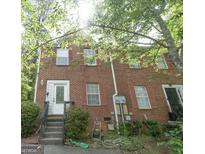 Brick townhouse with red shutters, white trim and a small front stoop surrounded by green foliage at 3191 Kingswood Gln, Decatur, GA 30034