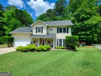 Charming two-story home boasts a well-manicured lawn, a welcoming porch, and lush greenery, creating delightful curb appeal at 508 Caxton Ct, Peachtree City, GA 30269