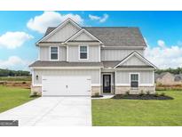 Charming two-story home featuring a two-car garage and well-maintained landscaping at 264 Oliver Dr, Locust Grove, GA 30248