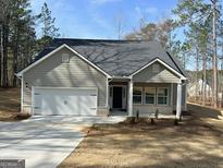Charming single-story home with a gray exterior, attached garage and manicured lawn at 5096 Cumberland Ct # 96, Villa Rica, GA 30180