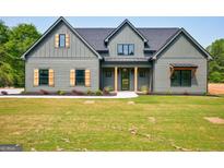 Charming craftsman-style home with a well-manicured lawn and inviting front porch at 4731 H D Atha Rd, Covington, GA 30014