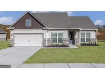 Charming single-Gathering home features a well-manicured lawn, two-car garage, and inviting entryway at 539 Cantrell Drive, Dallas, GA 30157
