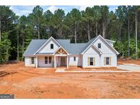 Beautiful new construction home with a white exterior, gray roof and lots of curb appeal at 4751 H D Atha Rd, Covington, GA 30014