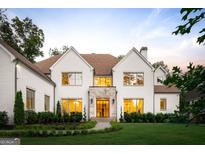 Stunning two-story home with a manicured lawn and a stone accent entryway at 490 Mount Paran Rd, Atlanta, GA 30327