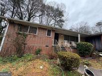Charming single-story brick home with covered porch, offering a classic and inviting curb appeal at 2234 Glendale Dr, Decatur, GA 30032