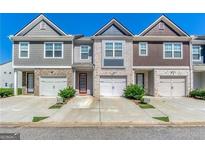 Attractive townhomes featuring single-car garages, private driveways, and colorful facades at 5009 Longview Walk, Decatur, GA 30035
