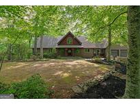 Charming home with lush green trees on a sunny day, complete with a quaint front yard at 9511 High Point Rd, Villa Rica, GA 30180