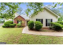 Charming single-story home with well-manicured lawn, walkway, and inviting curb appeal at 308 Dylan Way, Mcdonough, GA 30252