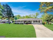 Charming brick home with a well-maintained lawn and classic architectural details, perfect for suburban living at 5327 David Se Cir, Covington, GA 30014