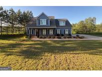 Charming two-story home featuring a well-manicured lawn, stylish front porch and tasteful landscaping at 808 Covered Bridge Rd, Covington, GA 30016