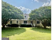 Charming single-Gathering home with a well-manicured lawn and mature trees, creating an inviting curb appeal at 105 Birch Creek Cir, Mcdonough, GA 30253
