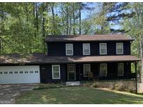 Charming two-story home with a welcoming front porch and a spacious two-car garage at 300 Martingale Dr, Peachtree City, GA 30269