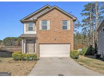 Charming brick home featuring a well-maintained front yard and a two-car garage at 5237 Halcyon Ct, Morrow, GA 30260