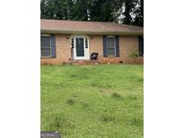 Charming brick home with well-manicured lawn and welcoming front porch, creating an inviting curb appeal at 2903 Revere Ct, East Point, GA 30344