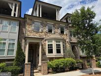 Charming stone and brick townhome with a private balcony and manicured landscaping at 1112 Cordia Nw Ave, Atlanta, GA 30318