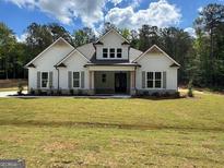 Charming single-Gathering home featuring a symmetrical facade and a well-manicured front lawn at 555 Discovery Lake Dr, Fayetteville, GA 30215