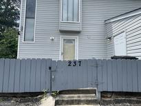 Charming home exterior with a welcoming front door and gray picket fence at 237 Country Club Dr, Jonesboro, GA 30238