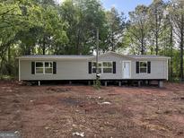Charming one-story home with neutral siding and dark window shutters at 30 Alyssa Ln, Bowdon, GA 30108