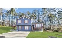 Charming two-story home with a covered carport and well-maintained lawn at 25 Stoneway Dr, Villa Rica, GA 30180
