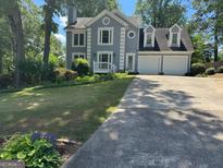 Charming two-story home featuring a spacious two-car garage, and lovely front yard at 4080 Longford Ne Dr, Marietta, GA 30066