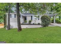 Charming single-story home with light colored brick and a well-maintained front lawn at 1814 Mary Lou Se Ln, Atlanta, GA 30316